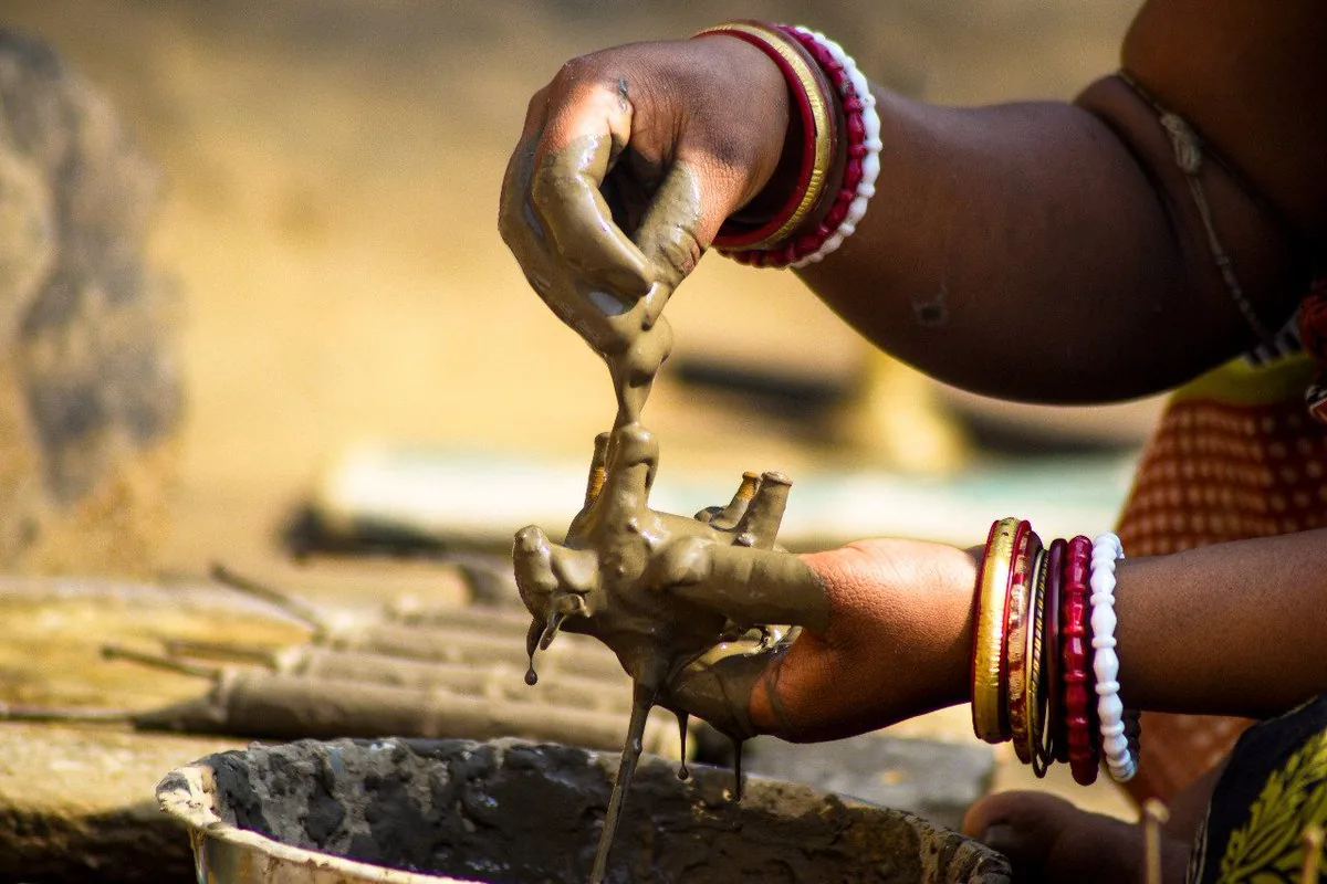 A Dharua tribal woman making a Dhokra cast — West Bengal